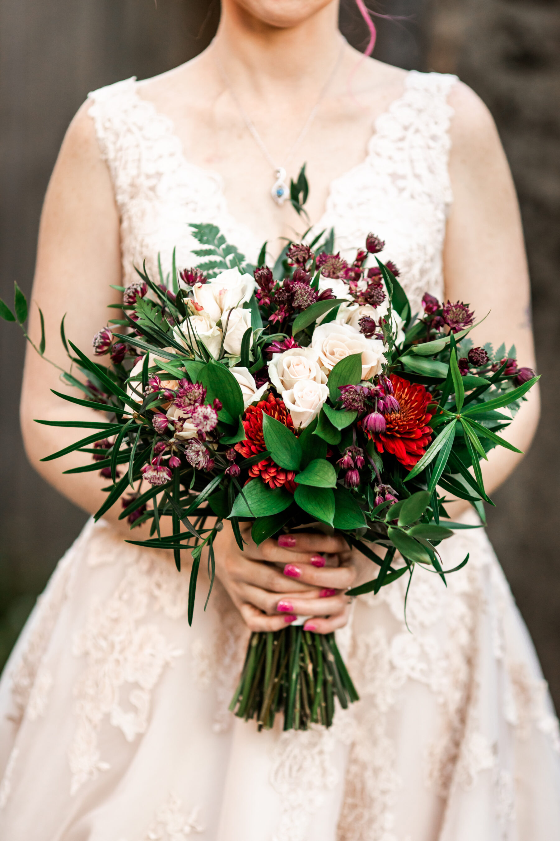 Red and white wintery wedding bouquet: Nashville Wish Upon a Wedding captured by Nyk + Cali Photography featured on Nashville Bride Guide