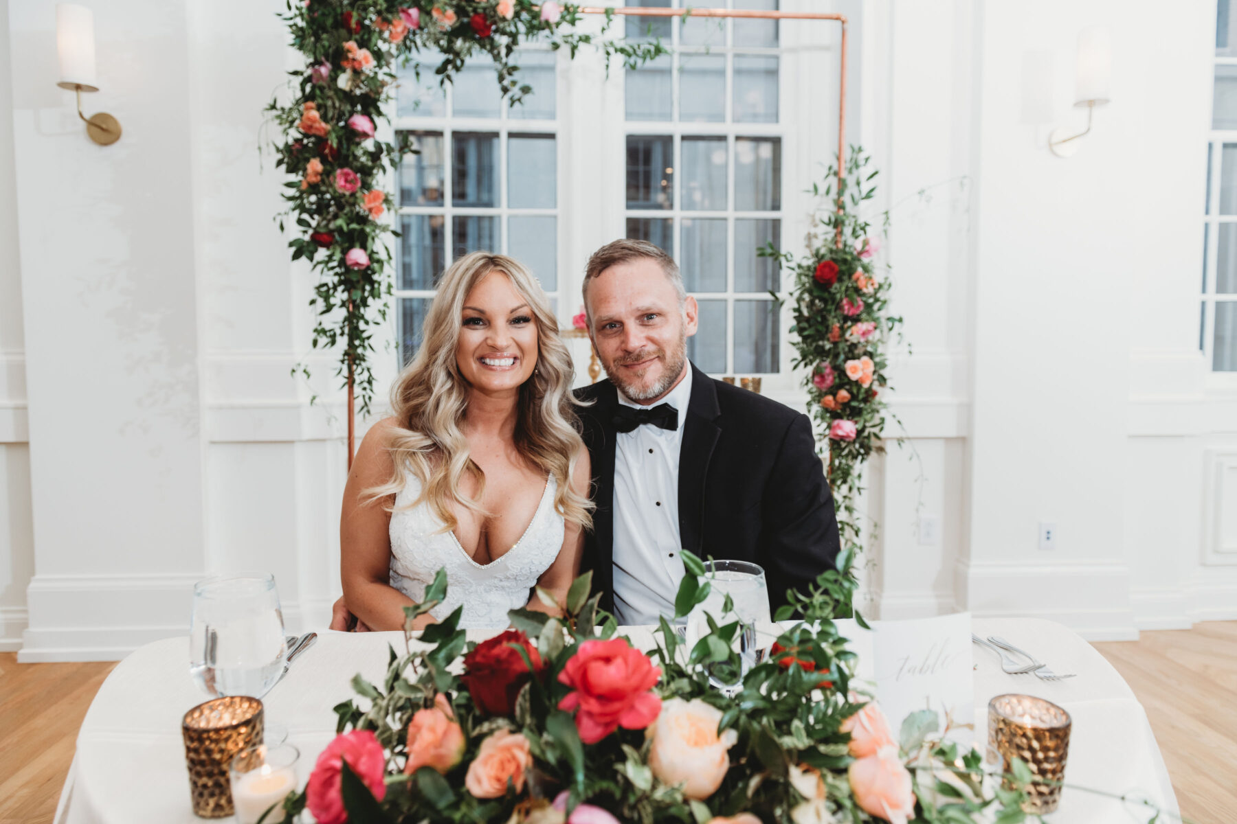 Coral and red floral wedding sweetheart table: Summer Tennessee Wedding at Noelle from Jayde J. Smith Events featured on Nashville Bride Guide