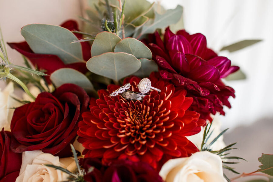 Wedding ring portrait on red wedding bouquet: Intimate Barn Wedding from John Myers Photography