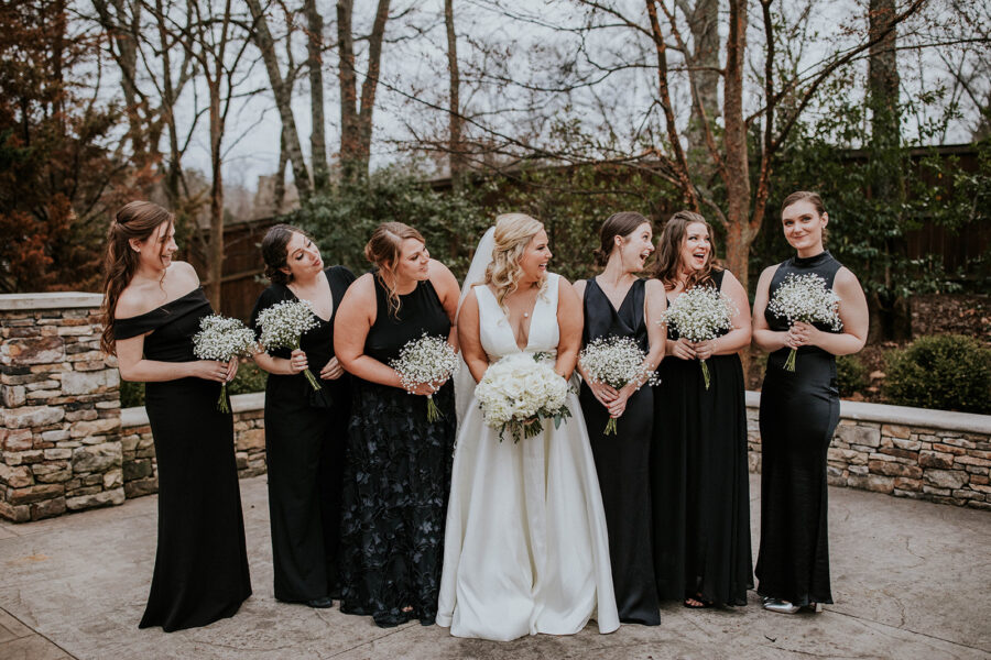 Black bridesmaid dresses and white wedding bouquets for winter wedding