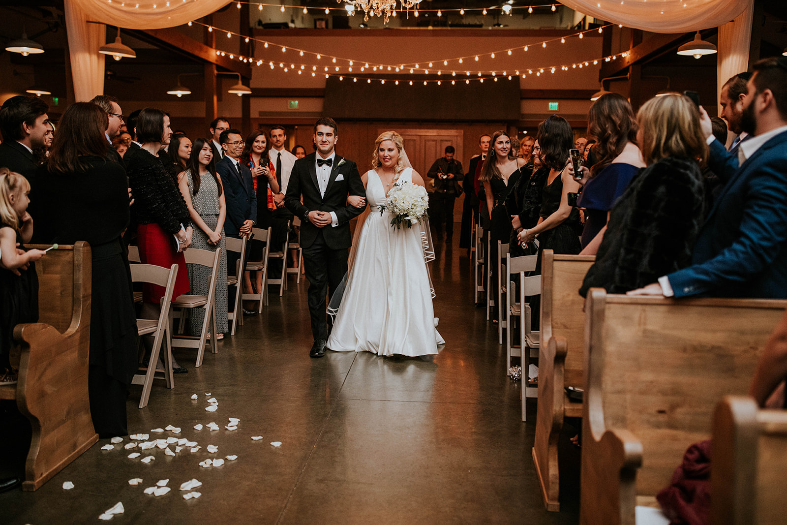 Bride being escorted down the aisle for winter wedding