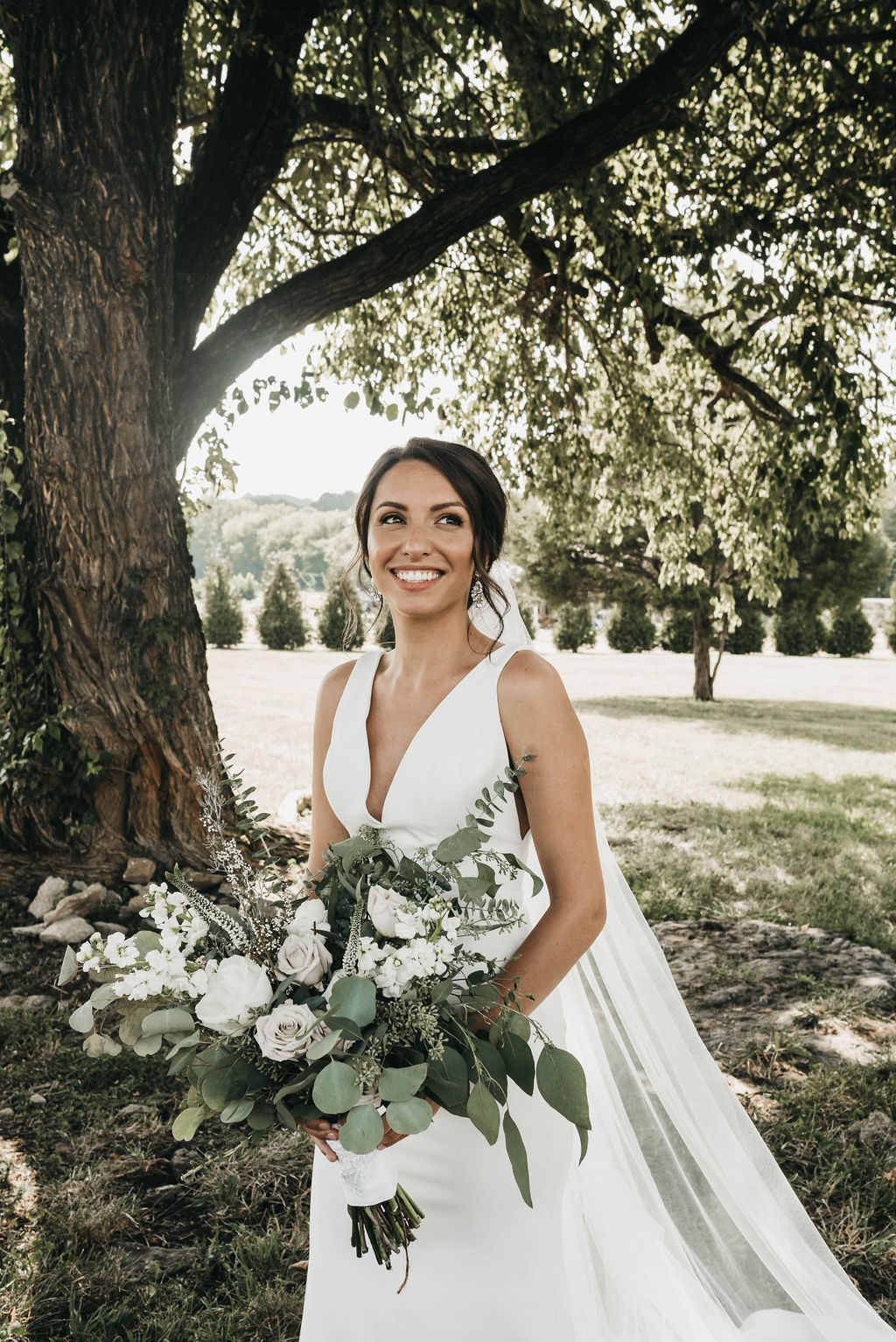 Bridal portrait with white and greenery wedding bouquet