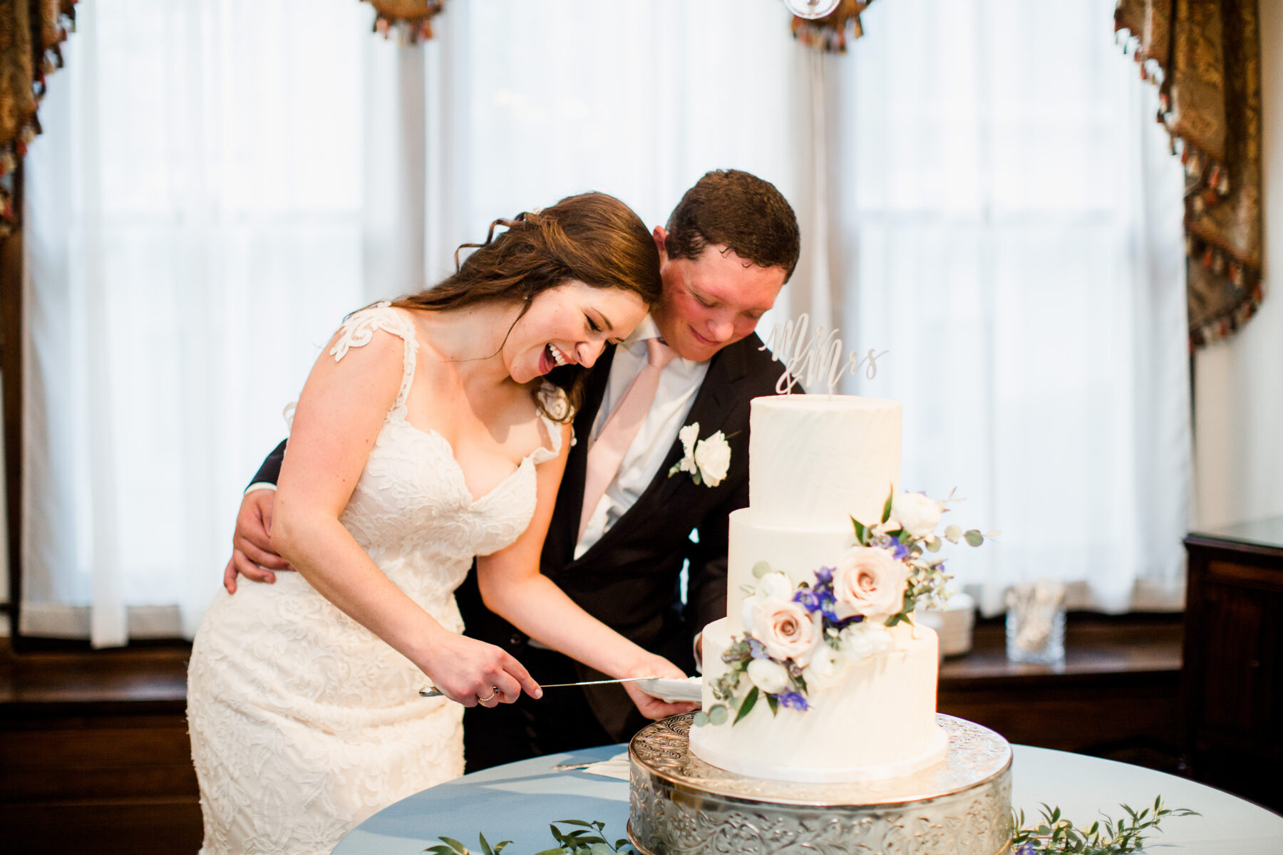 White floral wedding cake cutting | Nashville Bride Guide