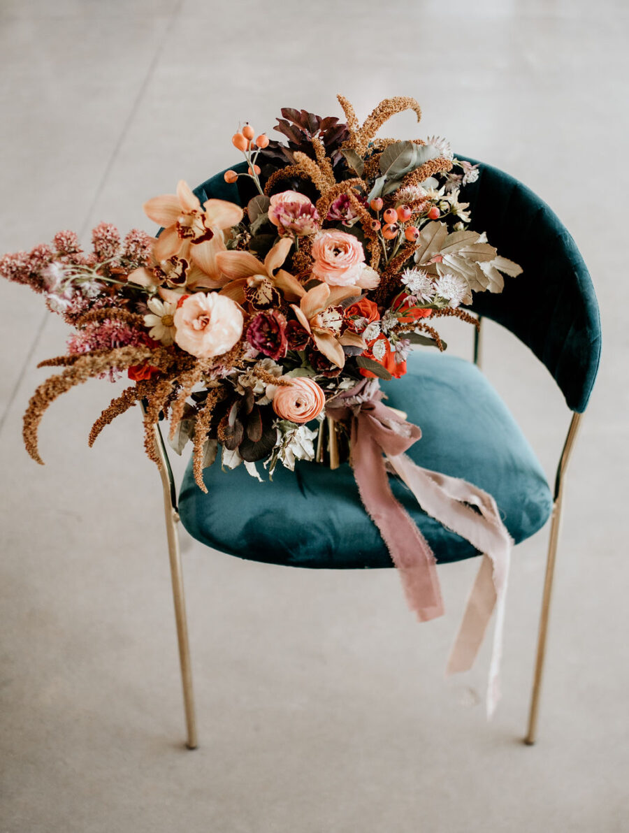 Large colorful wedding bouquet on velvet chair