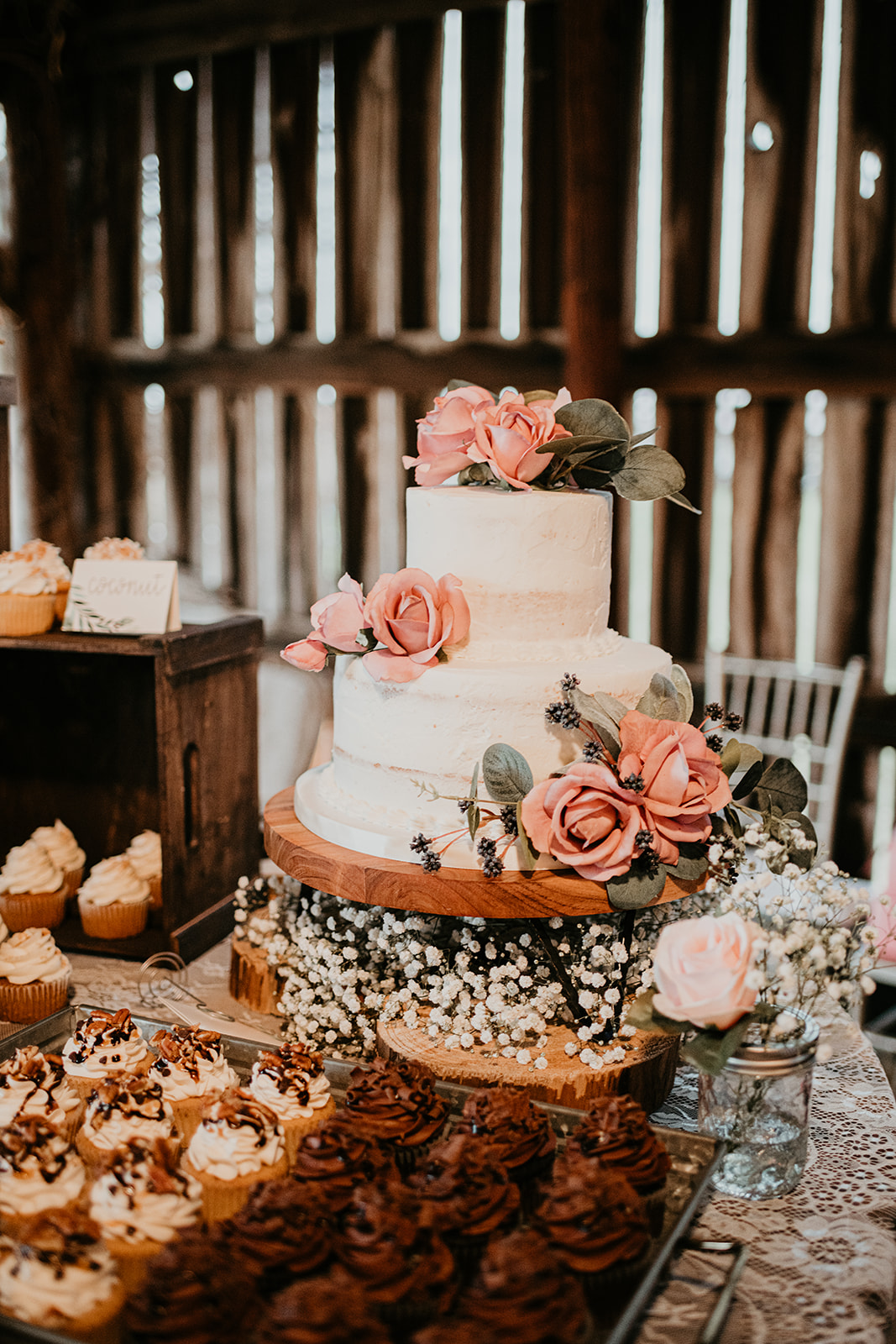 Rustic wedding cake with pink flowers
