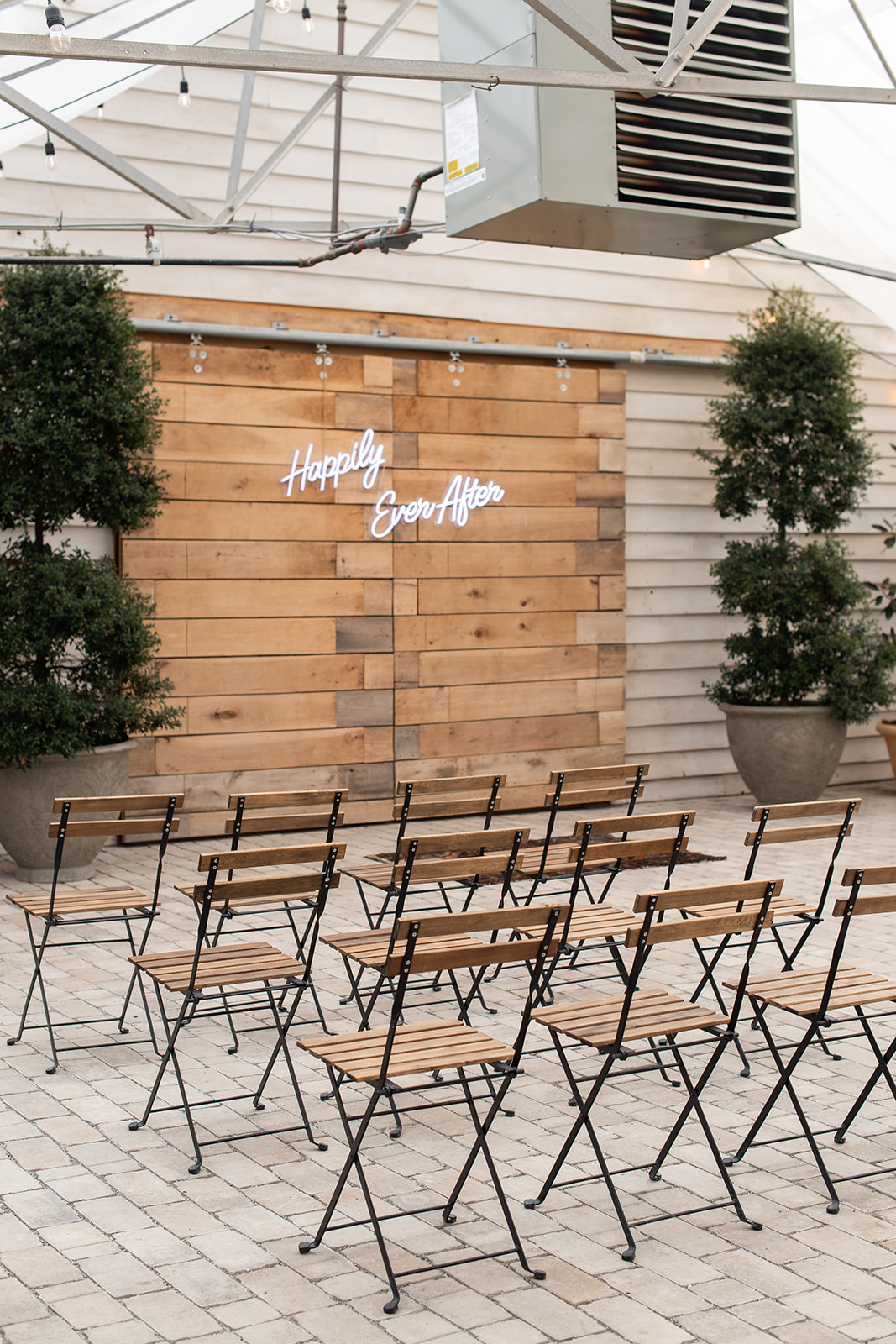 Bistro wedding chairs and neon wedding ceremony sign