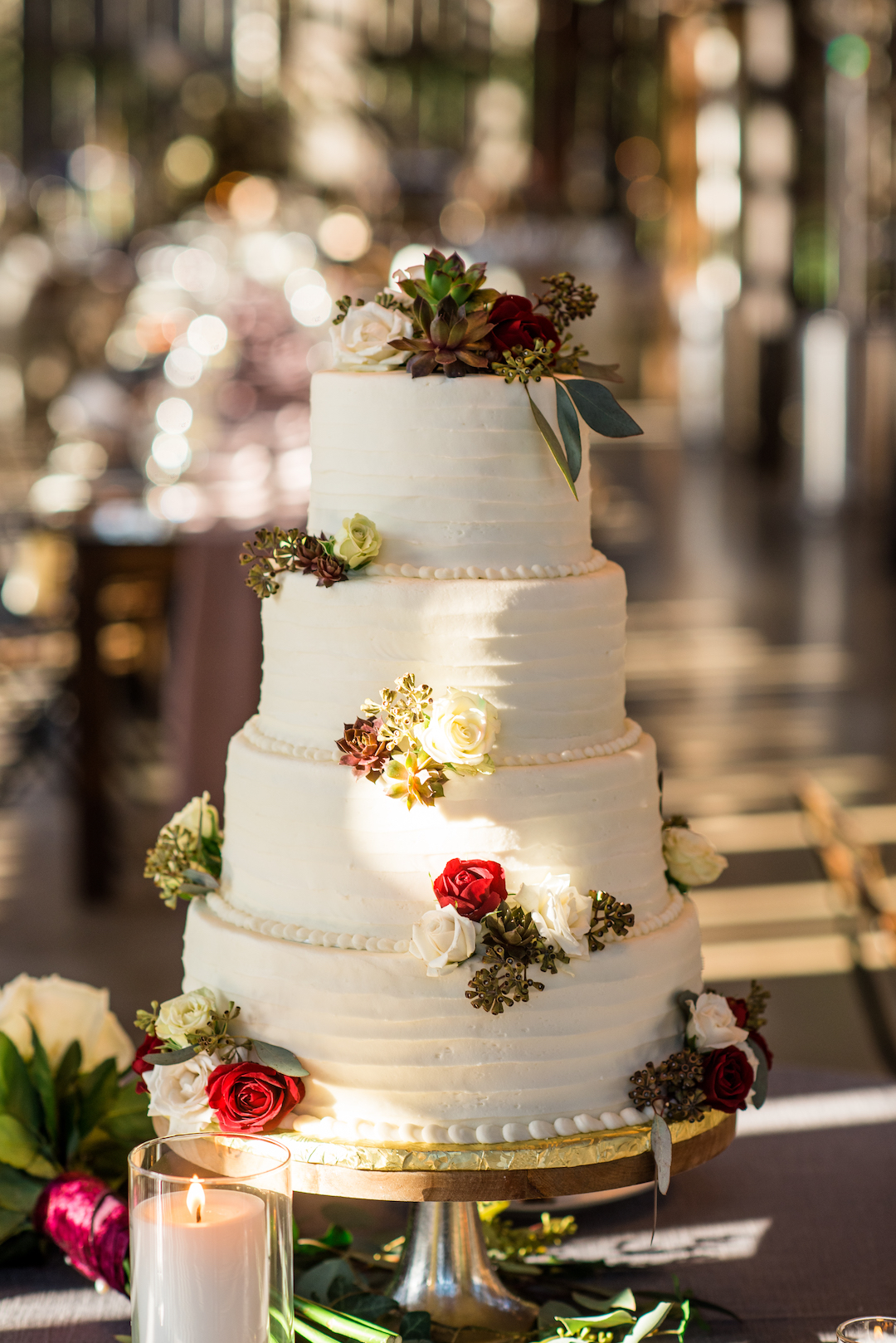 White wedding cake with red flowers
