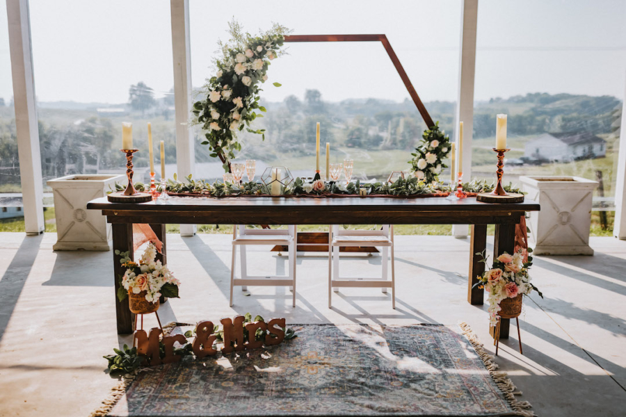 Rustic sweetheart table with geometric backdrop