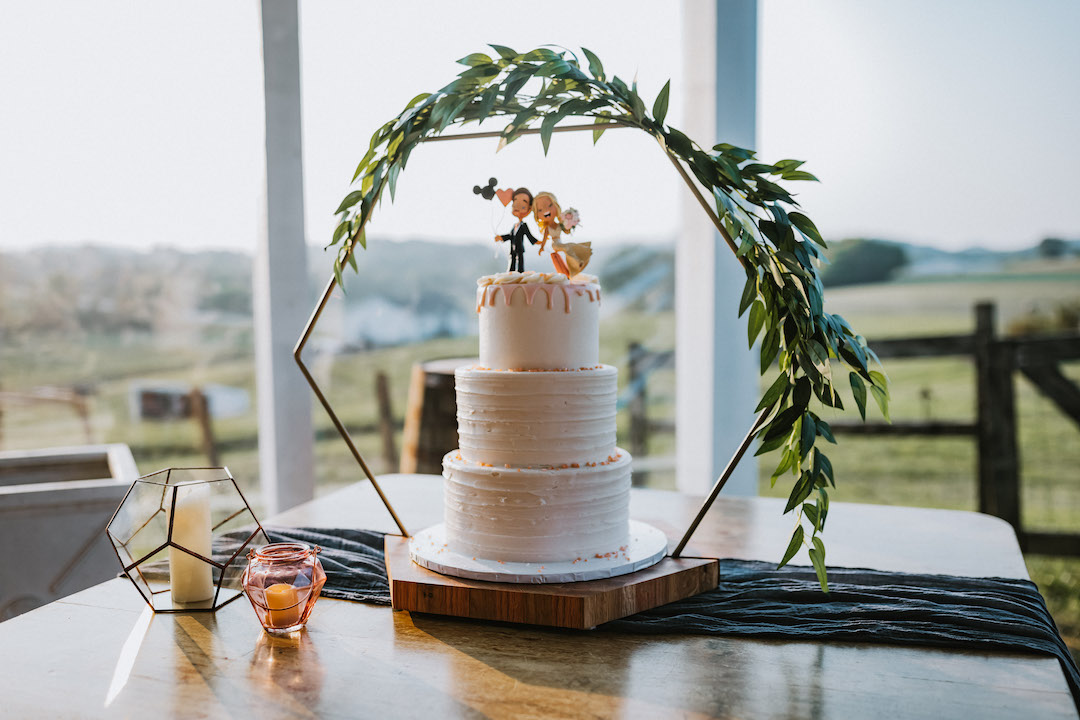 White wedding cake with geometric cake stand