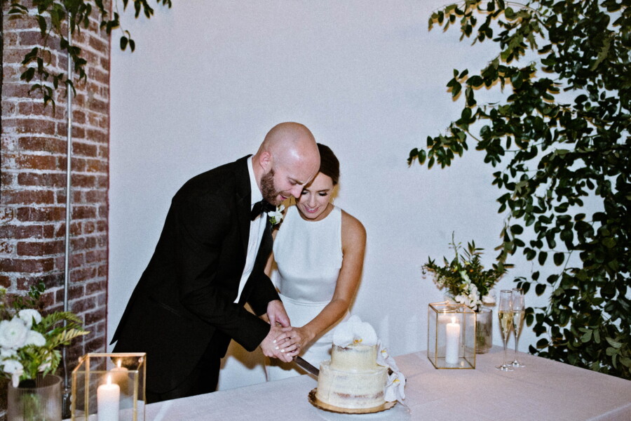 Bride and groom cutting small wedding cake