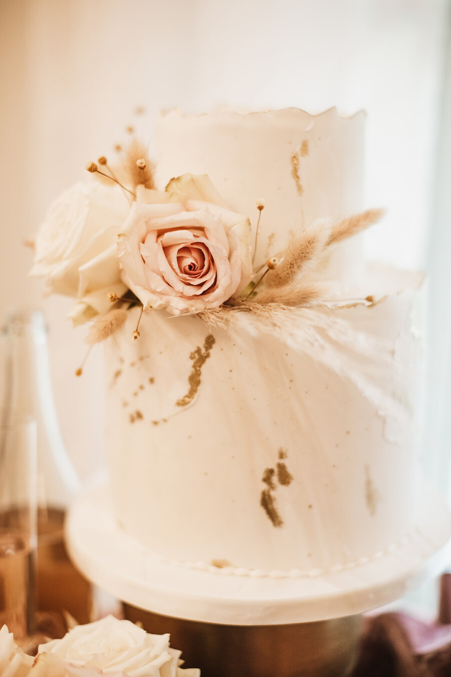 White wedding cake with bohemian flowers