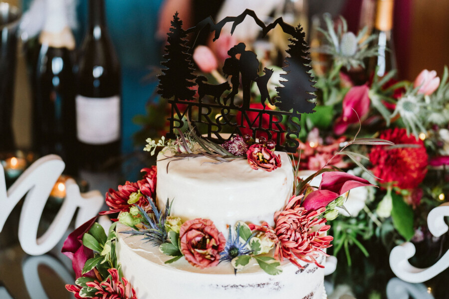 White wedding cake with bright flowers