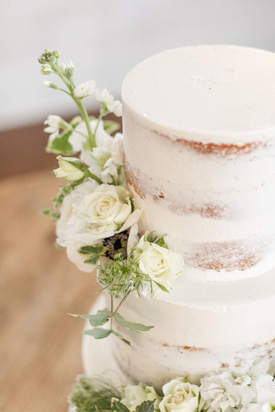Semi-naked wedding cake with flowers