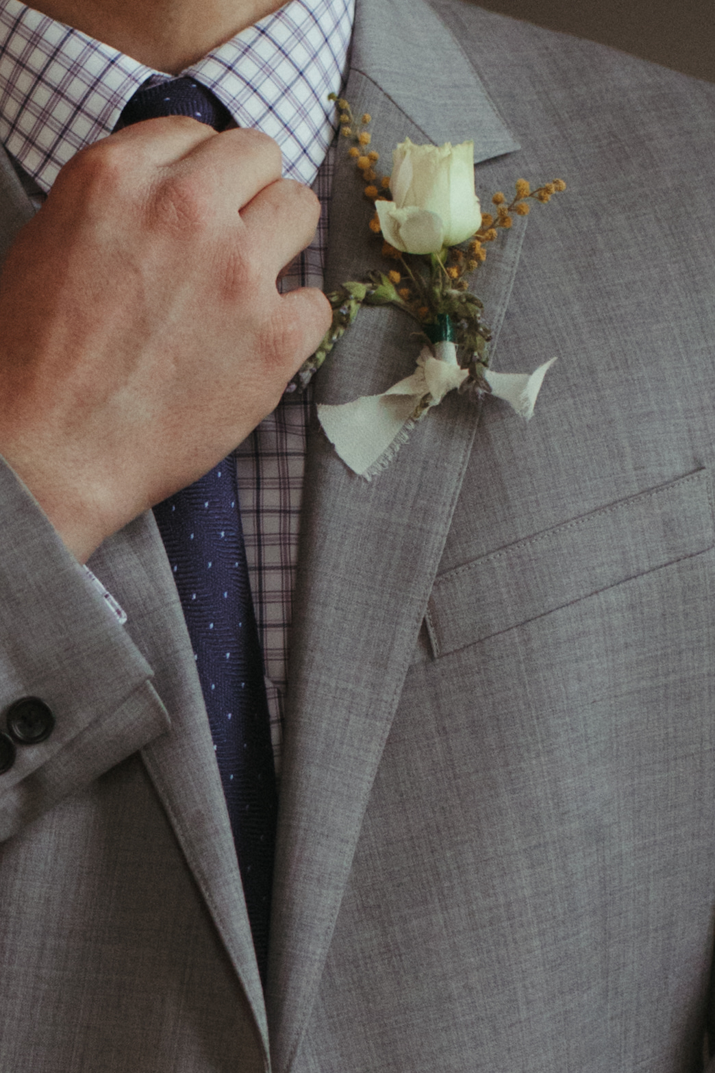 groom adusting tie
