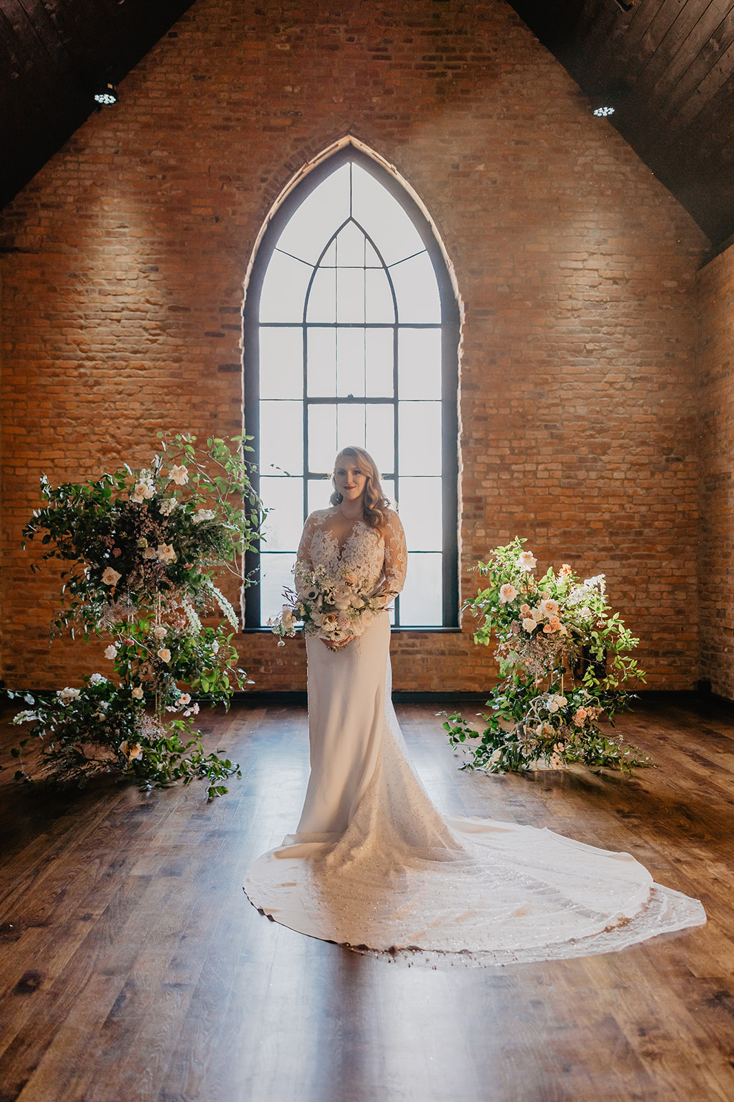 bride with ceremony backdrop
